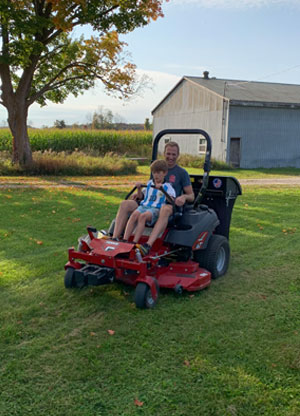 Dad and son cutting grass